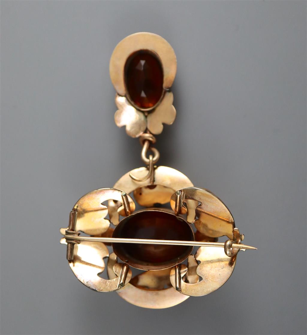 A Victorian engraved gold and two stone oval cut citrine set scrolling drop brooch,
